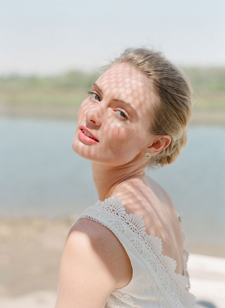 Chic Nostalgia’s lace and tulle gown from Palmetto Bridal Boutique. Tacori’s gold and prasiolite earrings from Diamonds Direct