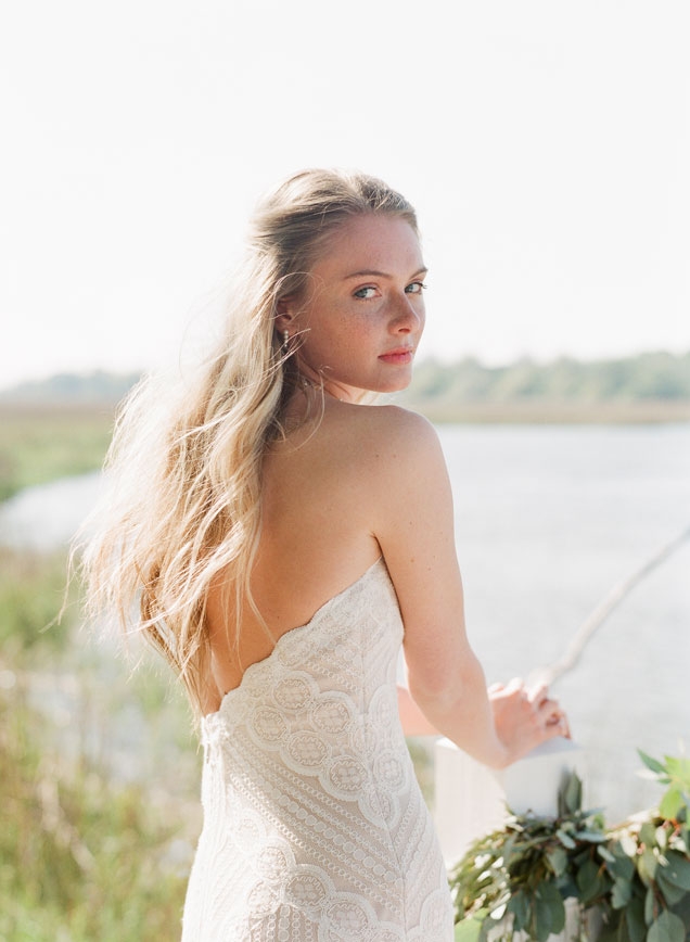 Wtoo’s “Betty” gown  available through  Fabulous Frocks and Jean’s Bridal. Birdsong’s pink stick pearl necklace from Kiawah Fine Jewelry. Pearl earrings from Paulo Geiss Jewelers. Garland by Fox Events