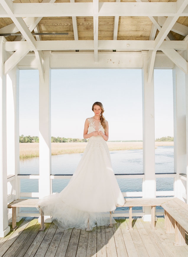 Sabrina Dahan’s “Marion” beaded and lace gown from Betty Bridal Atelier. Gold earrings and pearl cuff, both from Paulo Geiss Jewelers. Tai’s bangle and Christina Jervey ring, both from Gwynn’s of Mount Pleasant