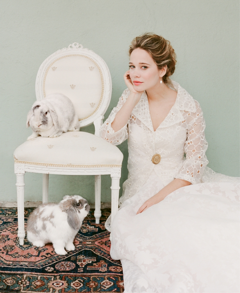 Jim Hjelm’s 8556 silk organza gown with floral print and detachable watteau train from Gown Boutique of Charleston. Ottod’Ame’s “Anna” eyelet jacket from Out of Hand. Stylist’s antique cameo pin. Diamond and pearl earrings from Roberto Coin.