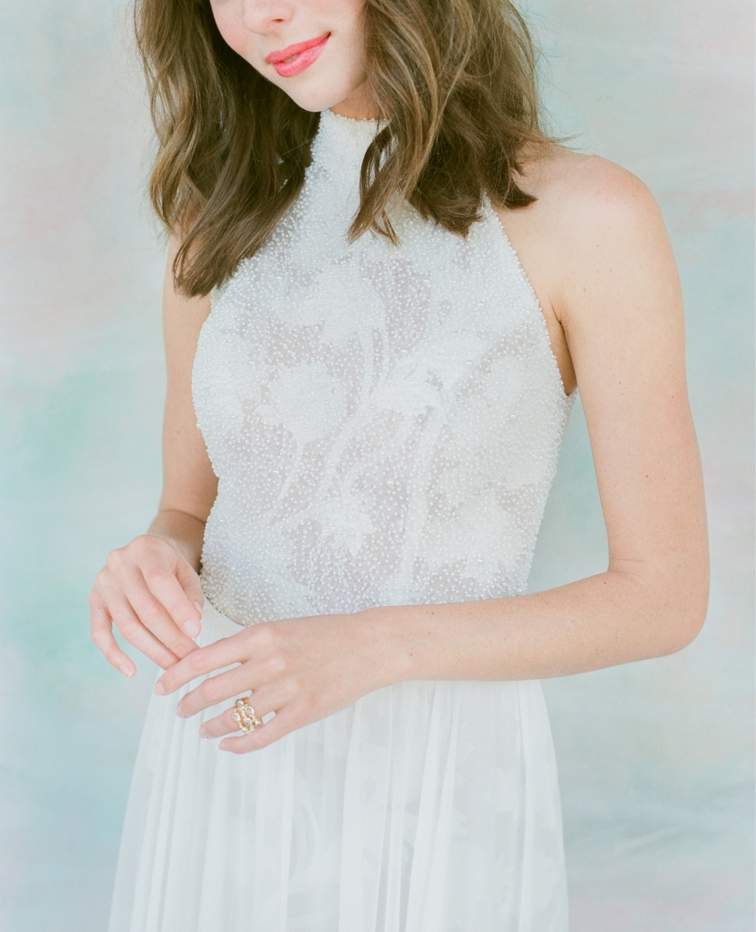 Limor Rosen’s “Jade”  leaf-embroidered lace gown with beaded halter top and chiffon skirt from  Lovely Bride. Mazza’s moonstone, diamond, and gold stacked ring from Croghan’s Jewel Box. Hand-painted backdrop by Anne Girault of  Boutique Tents.   &lt;i&gt;Photograph Corbin Gurkin&lt;/i&gt;