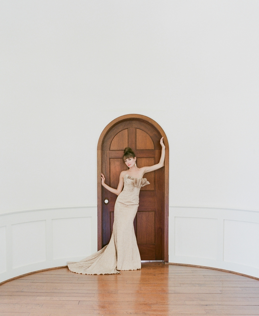 Carol Hannah’s  “Narcisseae” rose gold  metallic trumpet gown with pleated train and  bust from Southern  Protocol Bridal.  &lt;i&gt;Photograph Corbin Gurkin&lt;/i&gt;