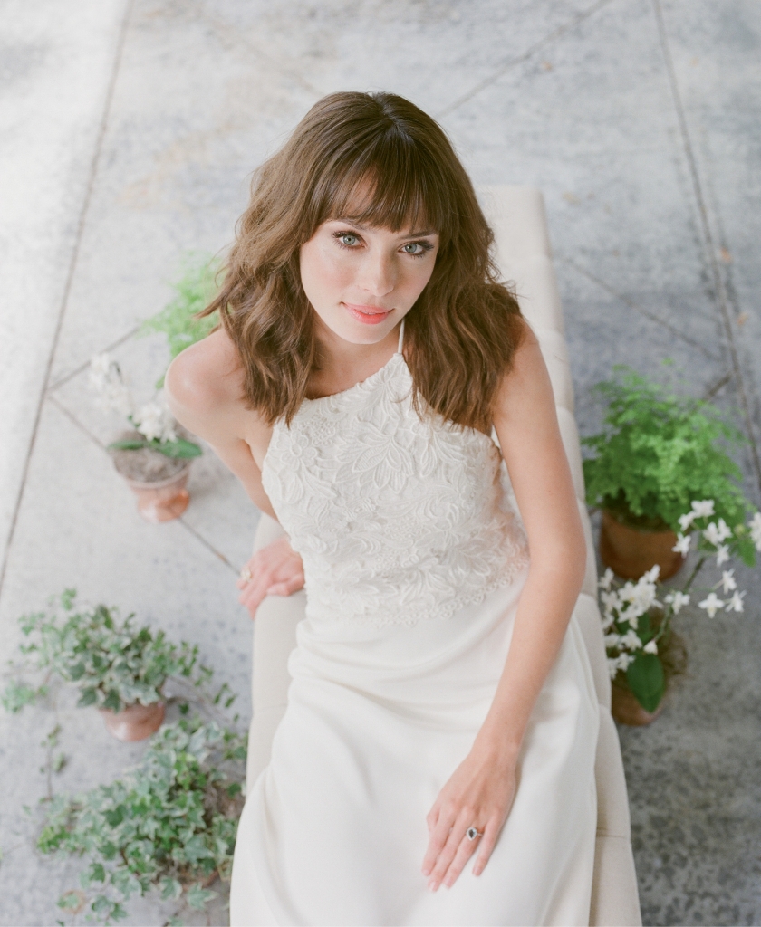 Katherine McDonald’s “Kipling” Guipure  lace and silk crepe  gown from Kate  McDonald Bridal  (also available through  Lovely Bride). Royal Jewelry’s blue topaz  and gold ring from Diamonds Direct.  Bench from Snyder Events. Plants from Roadside Blooms.   &lt;i&gt;Photograph Corbin Gurkin&lt;/i&gt;