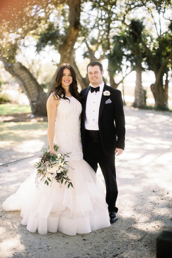 “I’m a no-fuss kind of girl who grew up in a large family of boys,” says Stephanie, explaining her low-key beauty on the glamorous day. “It wouldn’t have felt right to be made up in a way that wasn’t me.” Bride&#039;s gown by Lazaro (available locally at Gown Boutique of Charleston). Florals by Stems Floral Design by Jonie Larosee. Image by Timwill Photography at Lowndes Grove Plantation.