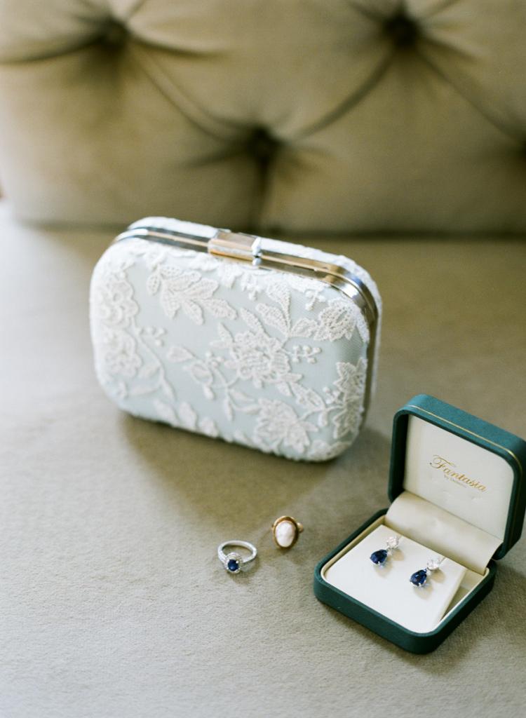SOMETHING BLUE: The bride’s father had given her a pair of blue sapphire earrings for her birthday, which she wore along with her blue sapphire engagement ring custom made by Matthew and Laurie Sarah Designs (found on Etsy).