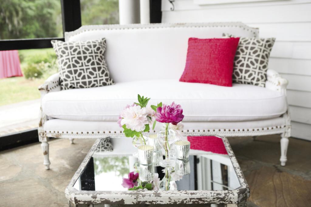 BIG IMPACT: A single pink pillow brought a fun, energetic punch to an otherwise formal sitting area. “Luke added little splashes of bright pink in certain places that really drew your eye,” the bride says.