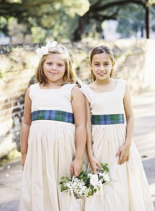 Flower girls wore the bride’s family tartan as sashes.  Florals by Blossoms Events. Photograph by Tec Petaja.