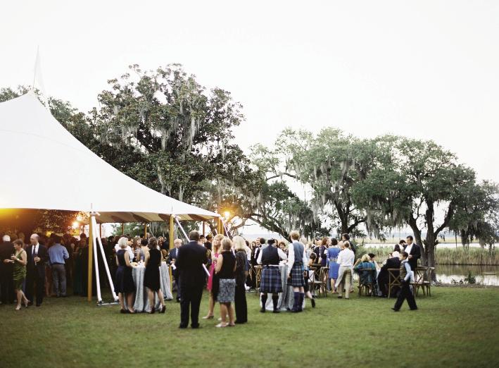 Though many of John’s relatives have wed at Estherville, he and Hollis were the first to celebrate on the  property’s front lawn, which overlooks Winyah Bay. Tent by Sperry Tents Southeast. Photograph by Tec Petaja.