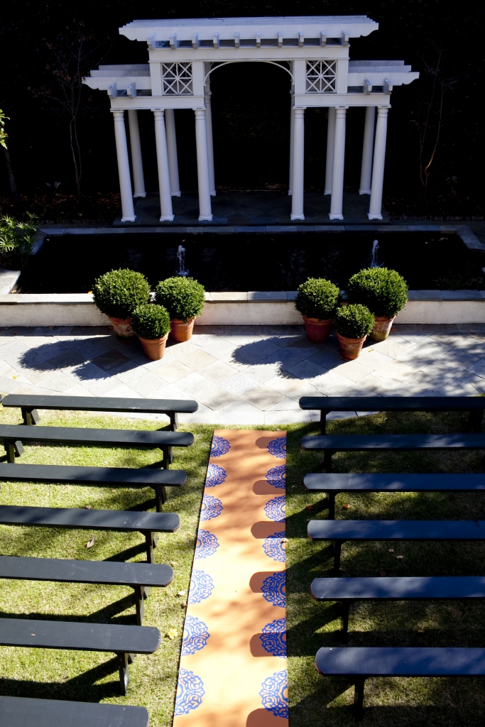 SET DESIGN: The ceremony was held in the backyard of the William Aiken House. Jessica and Ben’s 150 guests watched them exchange vows from benches arranged on either side of the custom-made aisle runner.