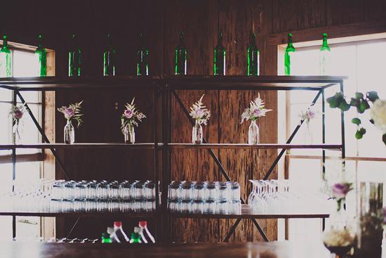BOTTLE SERVICE: Emerald wine bottles and rose arrangements accented the bar.