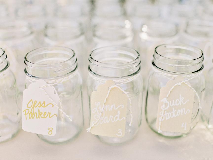 Jennifer used gold baker’s twine to tie butler cards to Mason jars that  doubled as the guests’ drinking vessels.
