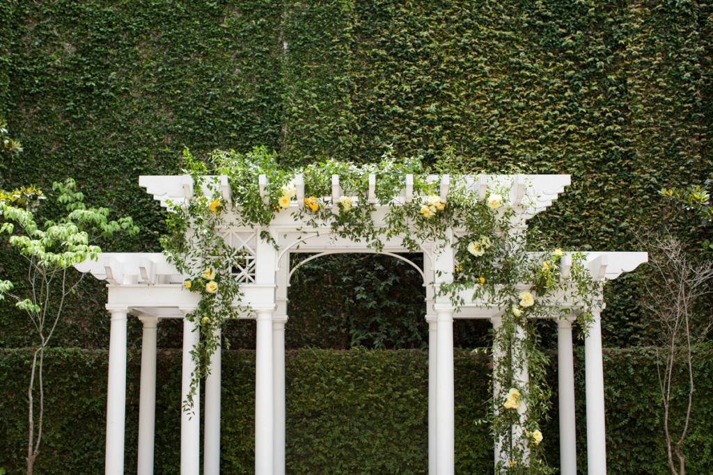 SMALL TOUCH: The William Aiken House and its grounds don’t need much decoration, so Gathering Events added simple yellow vines to the arbor for the ceremony.
