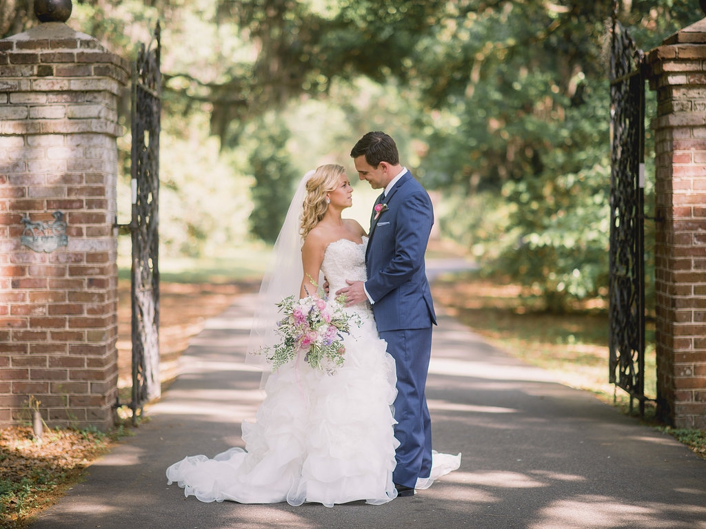 Gown by Allure Bridals. Hair and makeup by Paper Dolls. Tux by Stephen Geoffrey and from M. Dumas &amp; Sons. Florals by Branch Design Studio. Image by Timwill Photography at the Legare Waring House.