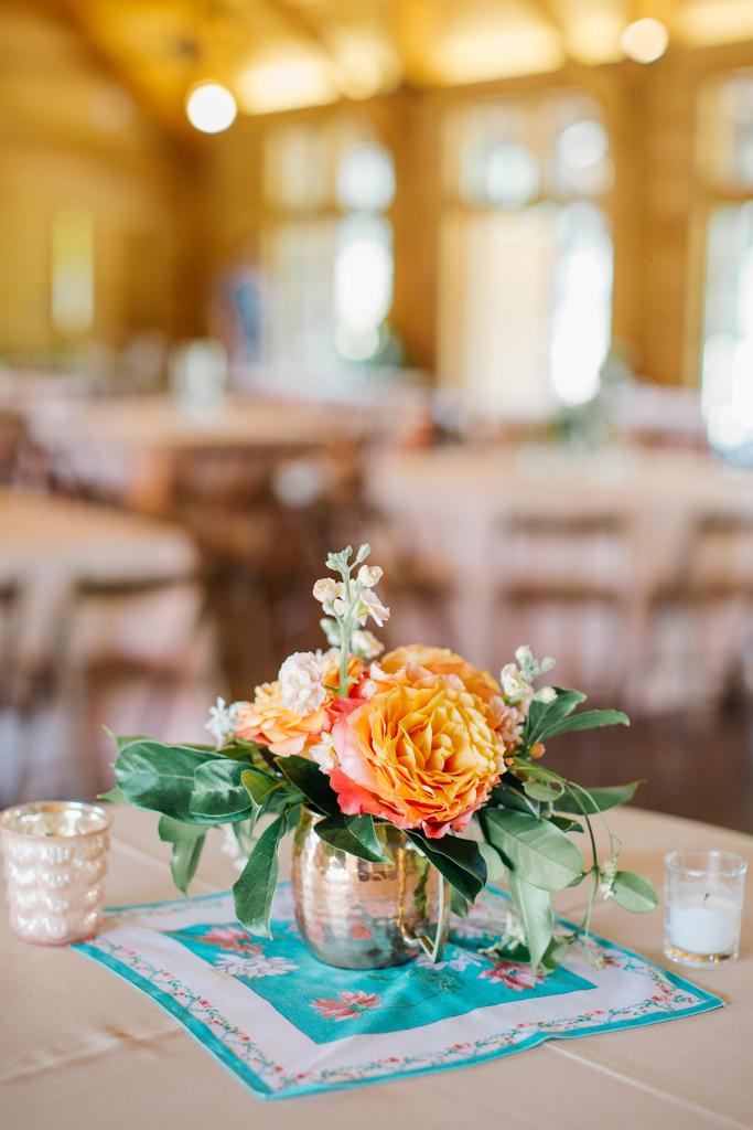 Work with Whatcha Got: A friend arranged blooms from Whole Foods and greens from her yard in flea-market vases that sat atop heirloom hankies from the bride’s family.