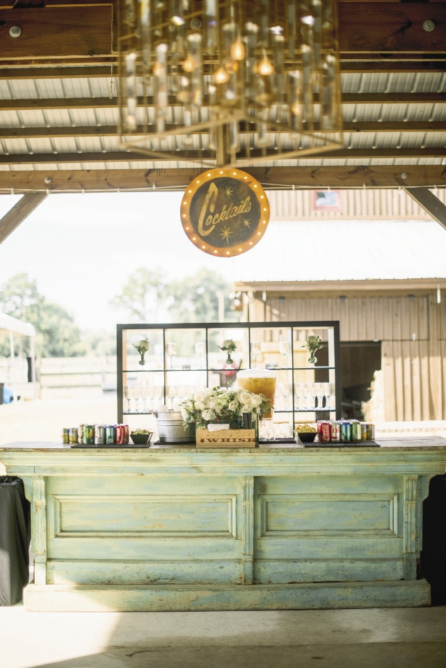 Specialty décor (like an Edison-bulb sign and wooden bar) gave depth, character, and color to the wedding’s chiefly neutral palette. The clue you’ve picked the right rentals? They look indigenous to your location.