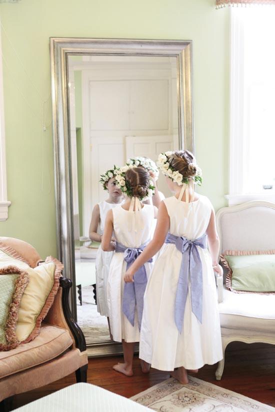 LADIES IN WAITING: Flower girls donned blush floral wreaths and cornflower silk sashes.