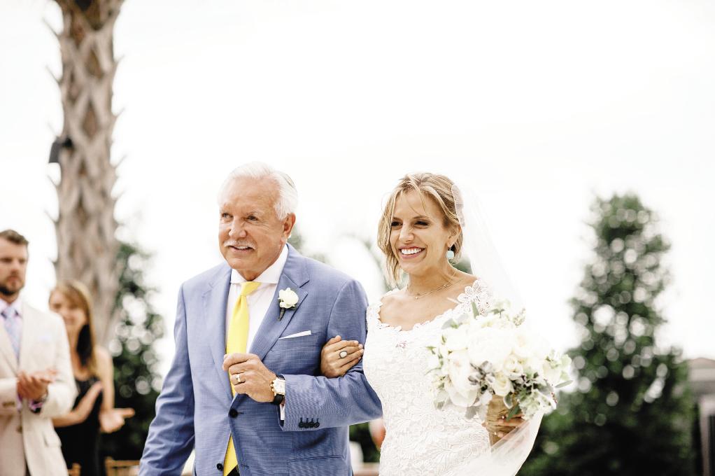 FATHER KNOWS BEST: Proud father  Tommy Baker escorted Katie down the aisle.  He and Jason donned suits in varying shades of blue; the groomsmen went casual with dark-wash jeans and vests.
