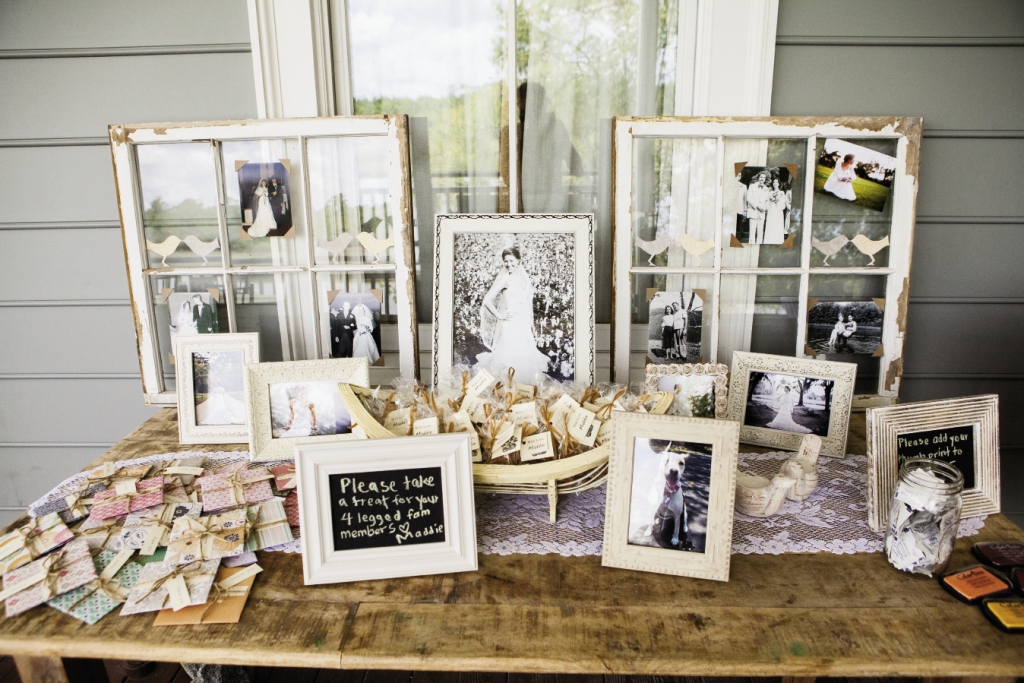 A FAMILY AFFAIR: The couple displayed their parents’ and grandparents’ wedding photos on two rustic window frames on the favor table.  Alongside their CD favors were gift bags with doggie treats to honor their pup, Maddie, who had to miss the festivities.