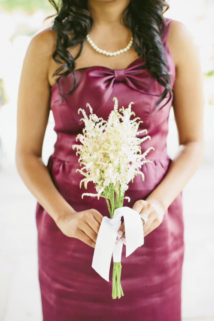 SOFT SIMPLICITY: Tiger Lily arranged simple, summery bouquets of white astilbe to soften the vibrant spiced wine color of the bridesmaids’ J.Crew dresses.