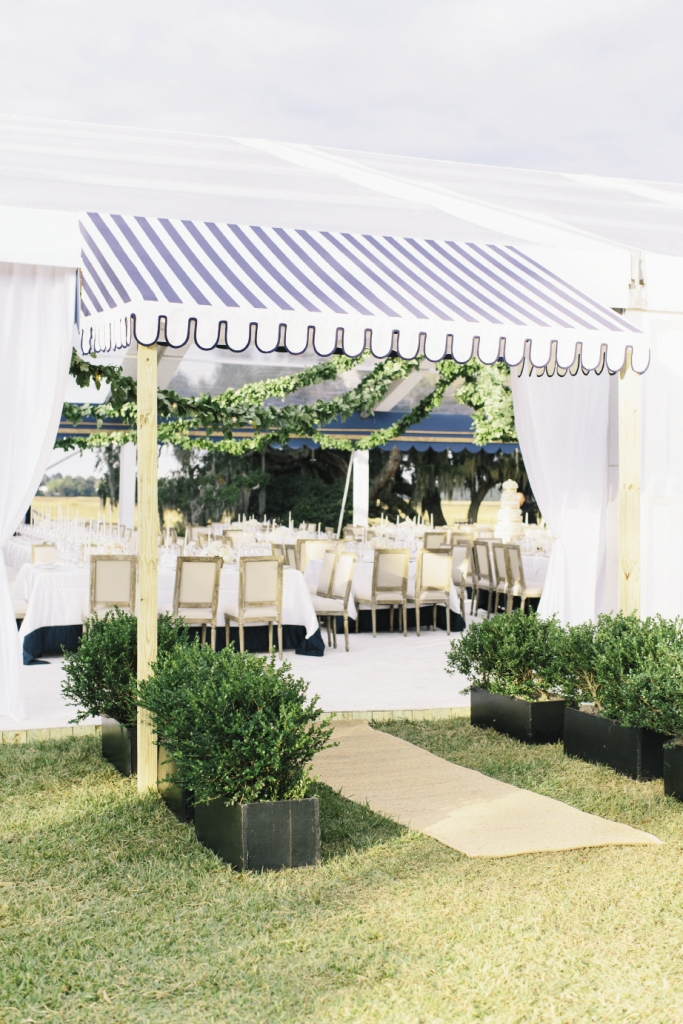 Reception tent entrances were made formal with custom-made fabric awnings and boxwood “hedges.”