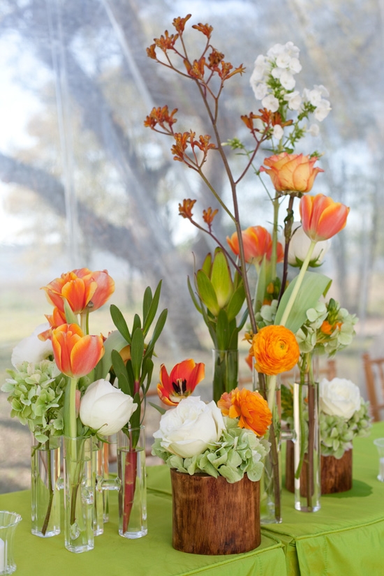 HIGHS AND LOWS: Vases of various heights and in assorted materials gave the mixed flora dynamic flare. Single stems grouped in a cluster like this creates a full centerpiece.