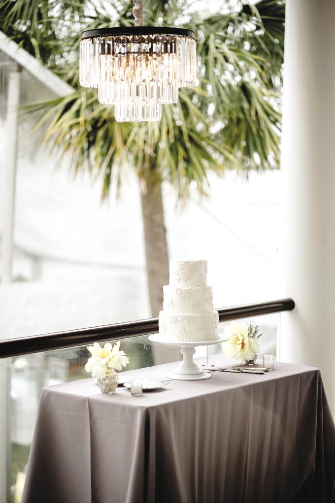 SCENIC OVERLOOK: Display your cake (like this one from Ashley Bakery) on the porch as a precaution against the  weather. Here, a chandelier adds elegance to the setup.