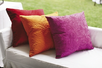 GET COZY: Adding color (and comfort), citrus- and berry-toned pillows lined benches.