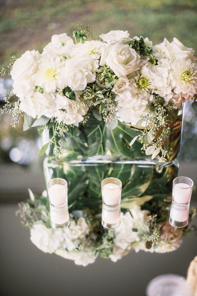 Here’s a neat trick: hide flower stems and floral foam when you wrap a tropical leaf around the inside of a glass vase before adding the arrangement.