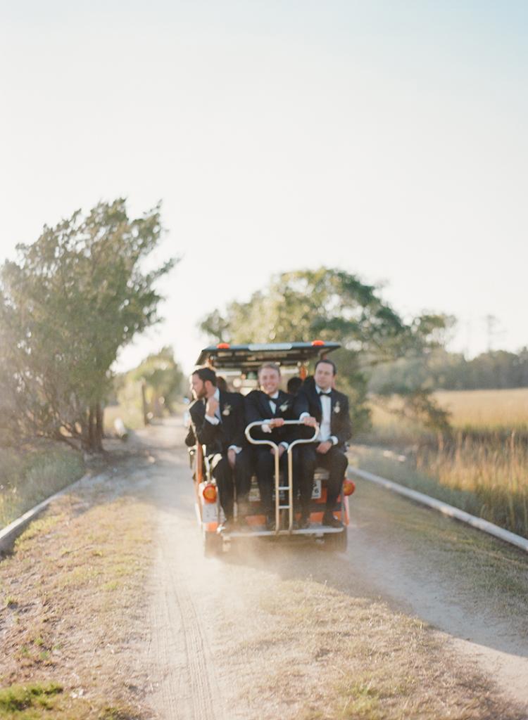 The groomsmen, along with 350 other guests, were shuttled by golf carts over a single-lane bridge to the secluded ceremony site.