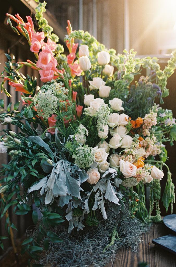 FLORABUNDANCE: “I wanted a lot of flowers, but I wanted all the flowers to have meaning. I used the Victorian flower dictionary and my coral, creams, and lilac colors to carefully choose all the flowers in my bouquet and in the centerpieces,” says Mary Jo.