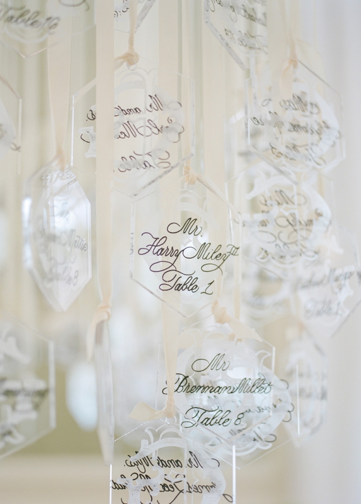 To pump up visual interest, Tara contrasted elements; here, Lucite ornaments (appropriate to the winter season) engraved with the couple’s initials and calligraphed with guest names and table numbers were hung with double-faced satin ribbon.   &lt;i&gt;Photograph by Corbin Gurkin&lt;/i&gt;
