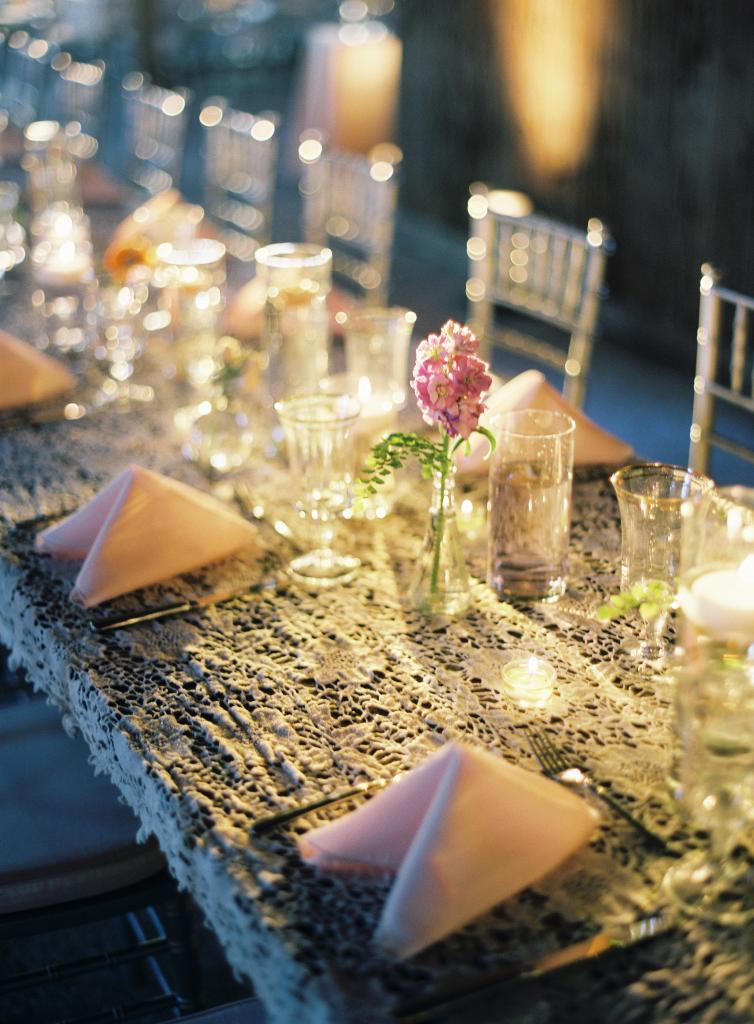 TABLE TALK: Simple tables got a vintage makeover with lace that Mary Jo handpicked and specially ordered for the day. Topped off with single stems, the tablescape offered a pretty but not overpowering place for guests to dine and mingle.