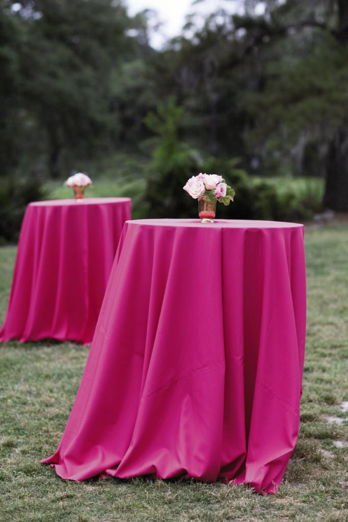 TOP THIS: High-top tables draped in fuchsia linens invited mingling and gave rich contrast to the lush green grounds.