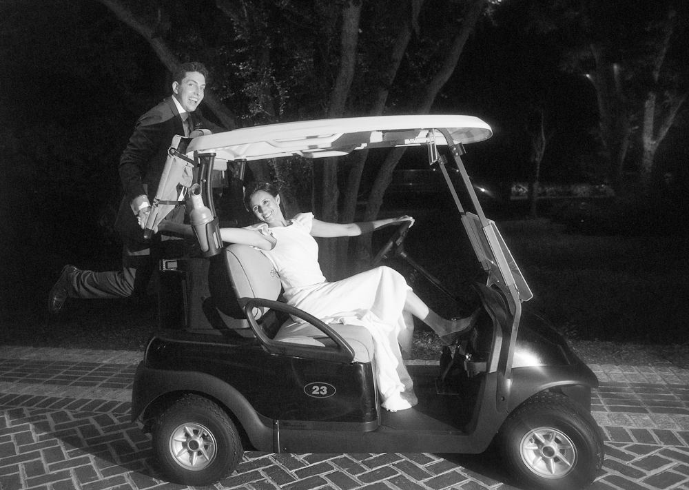 Bride&#039;s gown by Delphine Manivet. Menswear by SuitSupply. Getaway golf cart from River Course at Kiawah Island Club. Photograph by Captured by Kate at River Course at Kiawah Island Club.