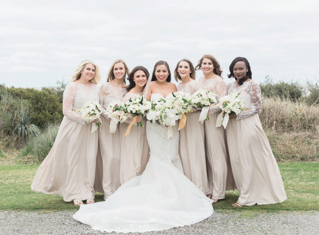 Fearing that white was too trendy for bridesmaids’ dresses, Gaby picked metallic gold sashes and sheer, lace bodices made for a striking contrast. The maids of honor’s bouquets were tied in gold-hued ribbon.  &lt;i&gt;Photograph by Corbin Gurkin&lt;/i&gt;