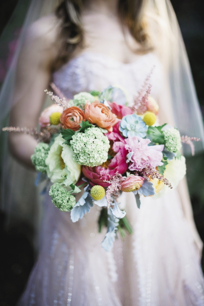 BREATH OF FRESH AIR: For a garden-style bouquet, Whitney gathered astilbe, craspedia, dusty miller, ranunculus, succulents, green viburnum, blush coral charm,  and yellow tree peonies together.