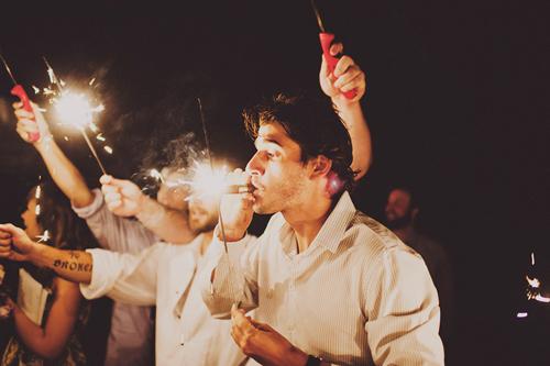 LIGHT UP THE SKY: Wedding guests illuminated the bride and groom’s departure with a sparkler sendoff. One crafty guest used his sparkler to light up a celebratory cigar.