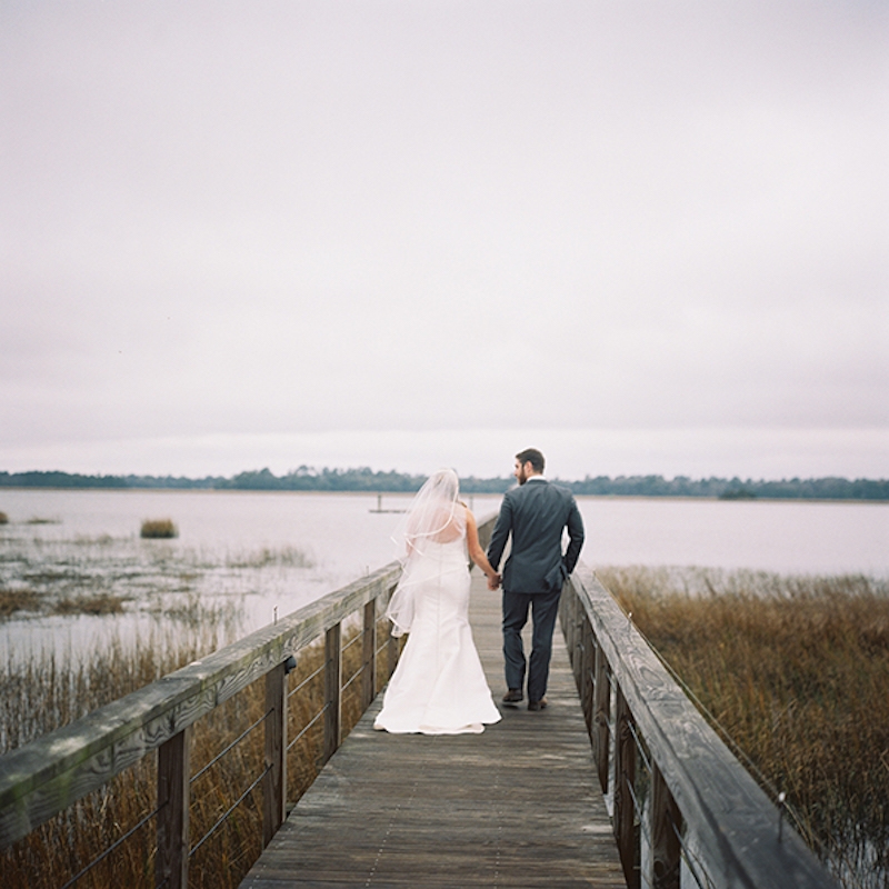 Bride’s gown by Amsale from White on Daniel Island. Menswear by Vera Wang from Mens Wearhouse. Image by Virgil Bunao Photography at Lowndes Grove Plantation.