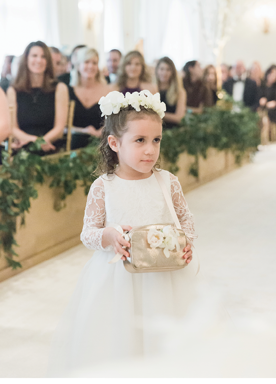 Flower girls, like three-year-old Dahlia, wore dresses that harkened those of the bridesmaids’ and carried rose petals in gold cross-body bags.   &lt;i&gt;Photograph by Corbin Gurkin&lt;/i&gt;