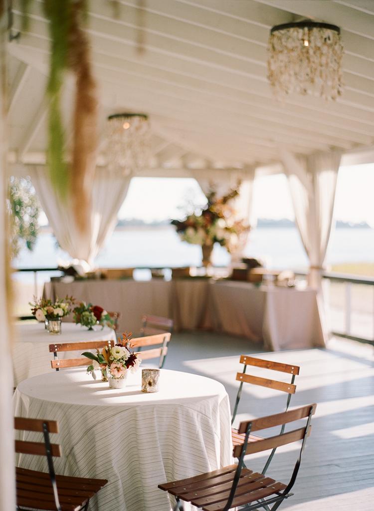 &quot;The bride and groom were raised in Charleston and they embody every aspect of the city’s character,” says planner Blake Sams, “so the vibe of the day was quintessential Lowcountry—beautiful without being flashy.” The aesthetic, he says, “was restrained and timeless, slightly handsome with soft details.” The way the yacht club’s deep porch was styled epitomized just that.