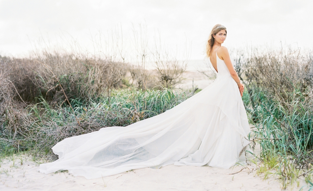 Carol Hannah’s “Lutosa” metallic silver gown from Southern Protocol Bridal. “Andes” smoky quartz crown by Emma Katzka. Hammered cuff from Out of Hand. Location: Seabrook Island, Beach Access 6. Photograph by Perry Vaile