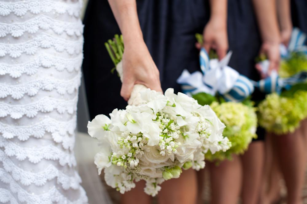 ALL IN LINE: Florist Sue Burden finished the bridesmaids’ hydrangea bouquets with bright blue and white striped ribbon.