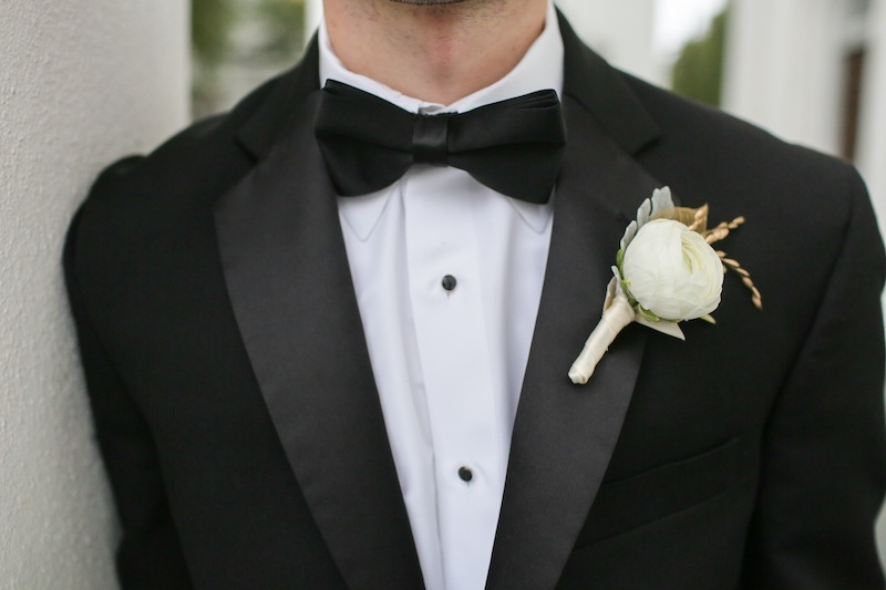 Groom’s attire from Berlin’s. Boutonniere by Charleston Stems. Image by The Connellys.