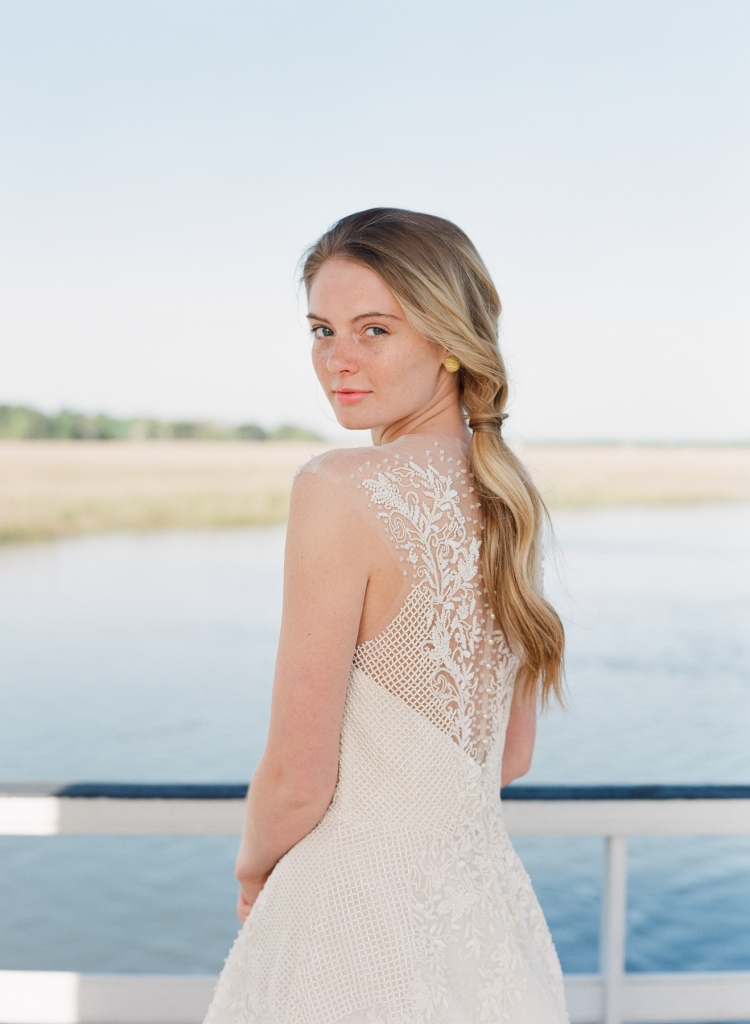 Sabrina Dahan’s “Marion” beaded and lace gown from Betty Bridal Atelier. Gold earrings from Paulo Geiss Jewelers