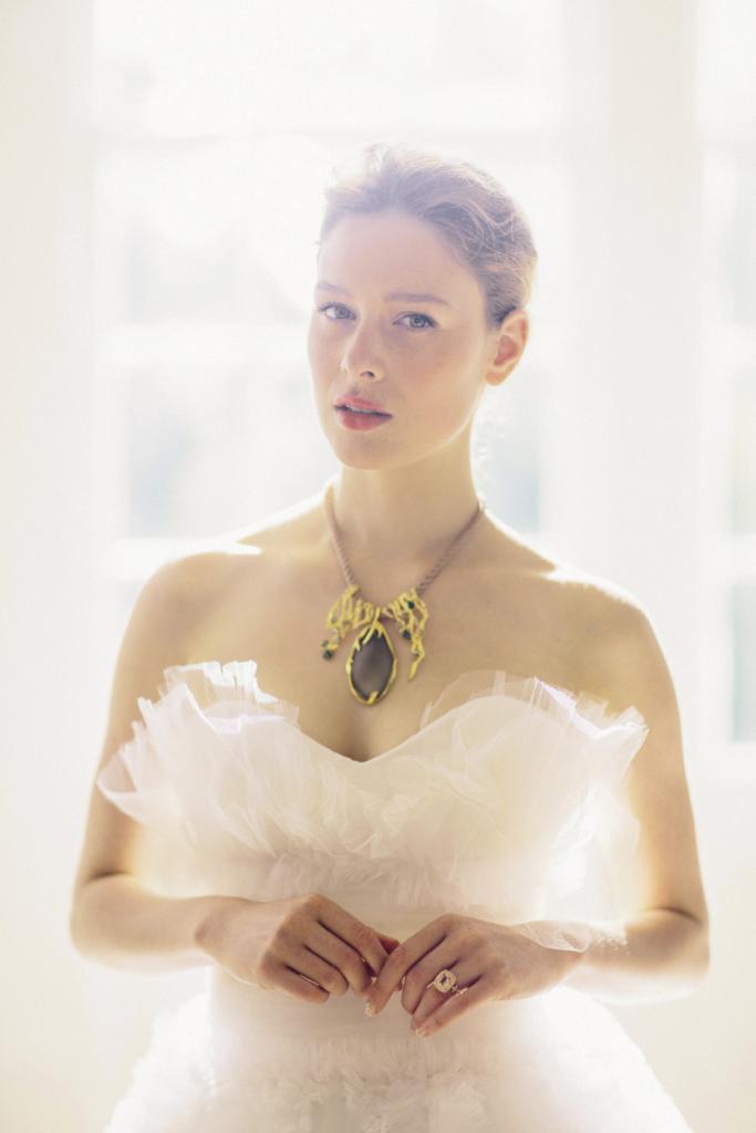 ETHEREAL MOMENTS: Alexis Bittar’s silk necklace with Lucite pendant from Gwynn’s of Mt. Pleasant. 18K rose gold ring with morganite and diamonds from Croghan’s Jewel Box. Marchesa’s ruffled and tiered tulle gown from White on Daniel Island.