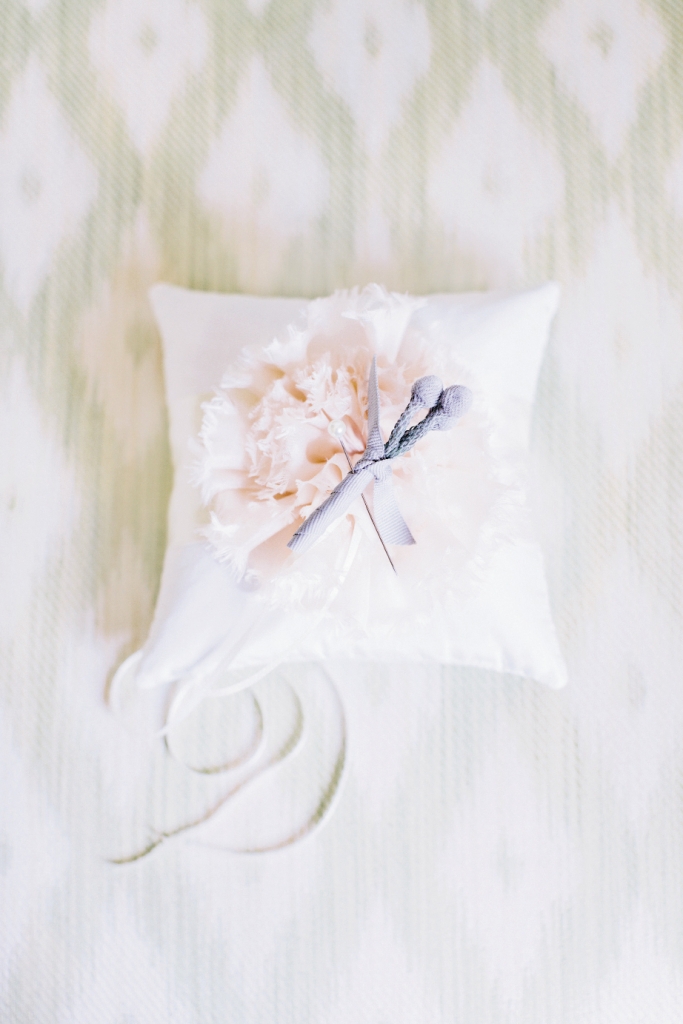 SOFT SPOT: Kim Morgan made this satin ring bearer pillow, while planner Tara Guérard crafted a silver brunia boutonniere tied off with grey grosgrain.