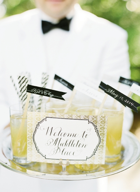 “X” MARKS THE SPOT: Upon arrival, guests were met with drinks  sporting handmade swizzle sticks and a custom map to guide them through the gardens to the ceremony, cocktail hour, and reception sites.