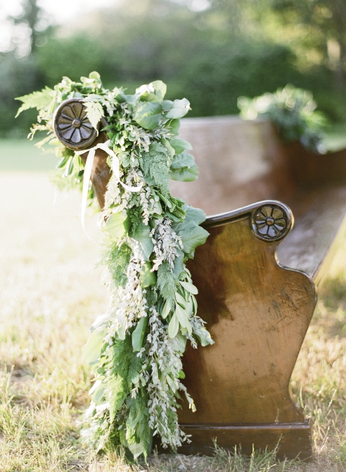 NEAT SEATS: Charleston Stems dressed up seating from P.E.W.S. with beribboned greenery garlands.