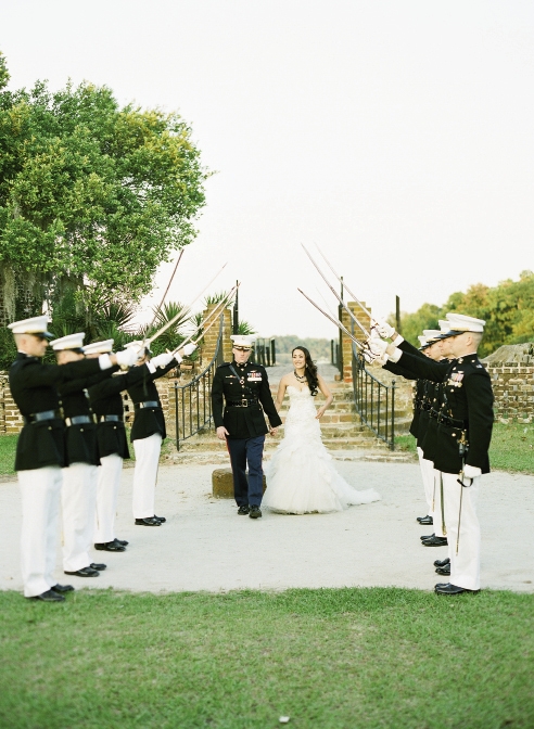 GOOD OL’ BOY: After the couple passed beneath the official Arch  of Swords, Maj. Chip’s  former roommate Capt. Kyle “DWIMM” Reilly customarily slapped the bride on the backside with the unofficial comment, “Welcome to the Marine Corps, ma’am!”