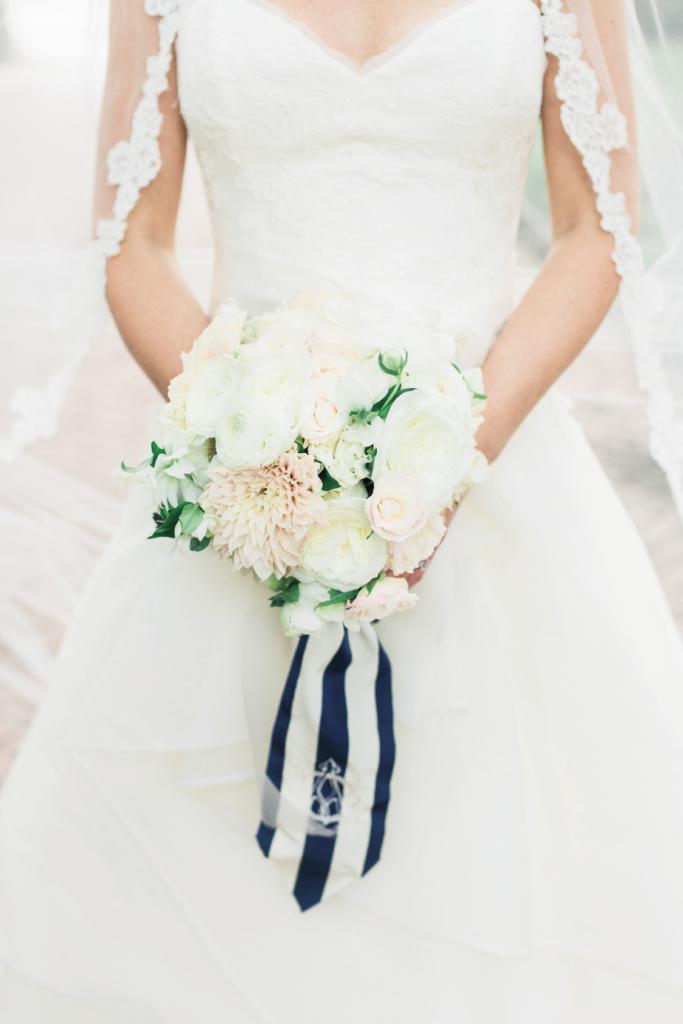 Monograms ran like a current through the wedding dominated by  a nautical blue and white palette. The anchor icon appeared on invitations and on  Annie’s bouquet wrap.
